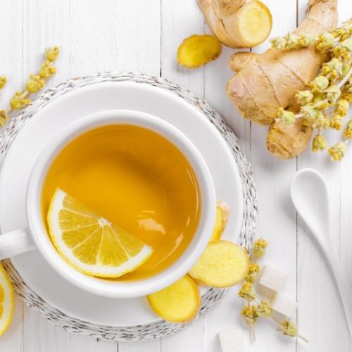 Top View White Mug with Liquid Surrounded by Lemon and Ginger | Vitacost Blog
