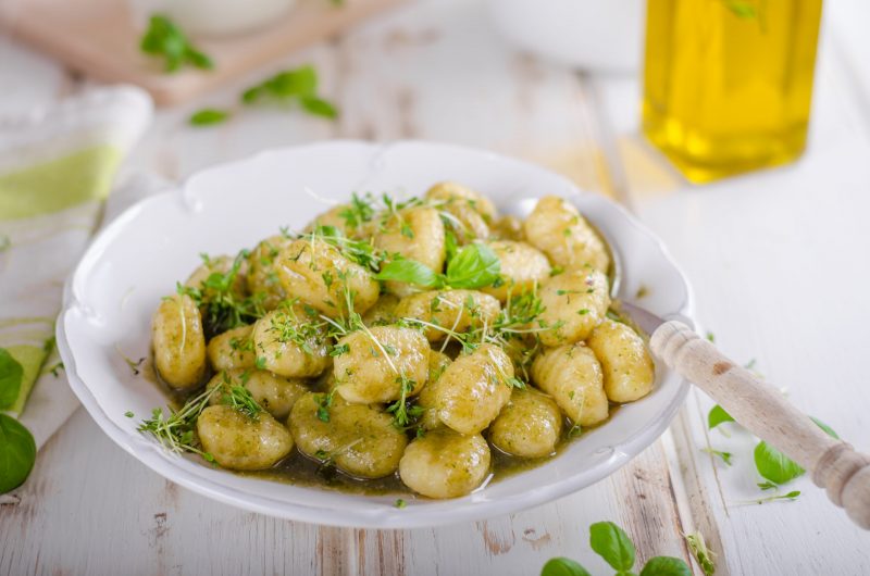 Cauliflower Gnocchi Garnished with Green Herbs in White Bowl | Vitacost Blog
