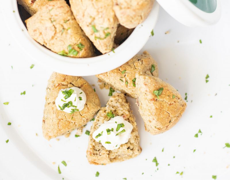 Top View Scones with White Cream on Table Next to Open Bowl of Scones | Vitacost Blog