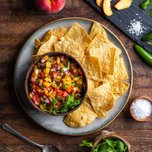 Peach Salsa in Cup on Plate Next to Tortilla Chips | Vitacost Blog