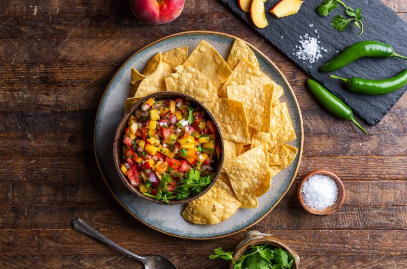 Peach Salsa in Cup on Plate Next to Tortilla Chips | Vitacost Blog
