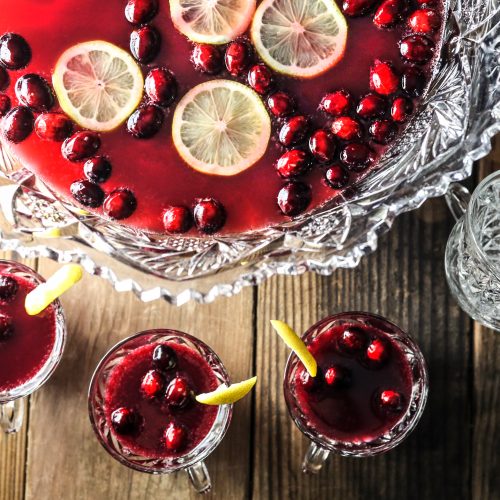 Top View Glass Bowl Filled With Red Beverage Garnished with Cranberries and Lemon Slices | Vitacost Blog