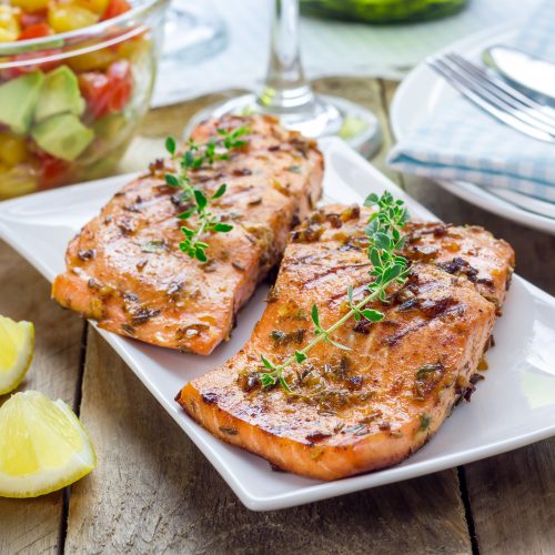 Salmon on White Plate in Front of Bowl of Mango Salsa | Vitacost Blog