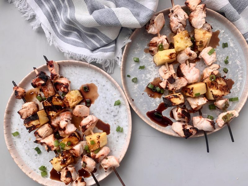 Top View Chicken and Pineapple Kebabs on Plates Drizzled With Brown Sauce | Vitacost Blog