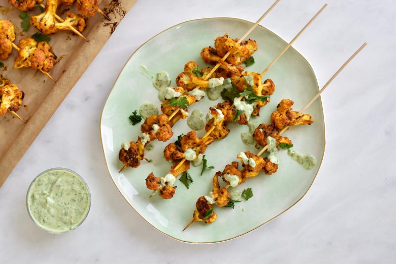 Top View Cauliflower Kebabs Garnished with Green Sauce on Green Plate | Vitacost Blog