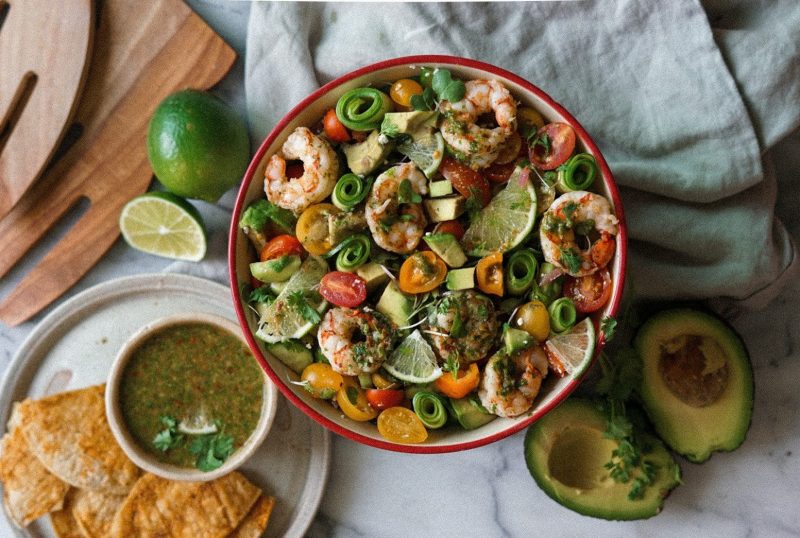 Top View Bowl of Shrimp, Tomatoes, Avocado & Lime Next to Fresh Avocado, Chips and Salsa | Vitacost Blog
