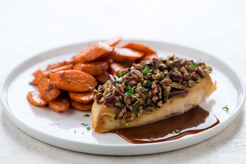 Pecan-Crusted Chicken Breast with side of BBQ-spiced Carrots on White Plate