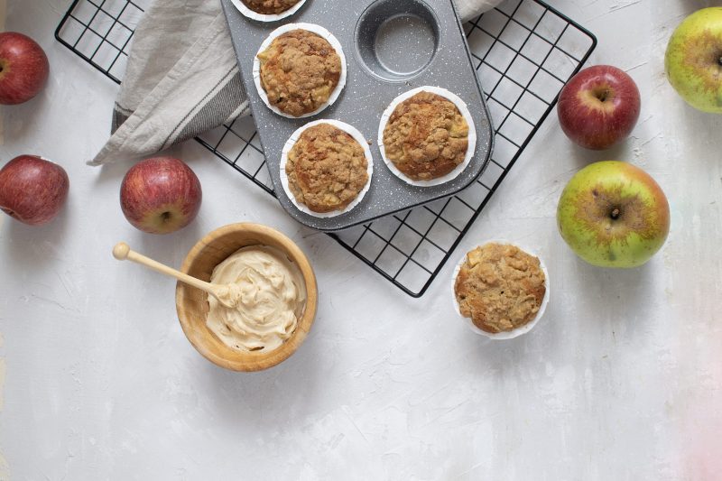 Top View Muffins Coming Out of Tin Next to Fresh Apples | Vitacost Blog