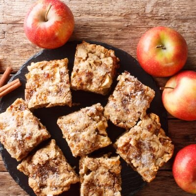 Top View Rustic-Style Apple Blondies Next to Fresh Apples on Wood | Vitacost Blog