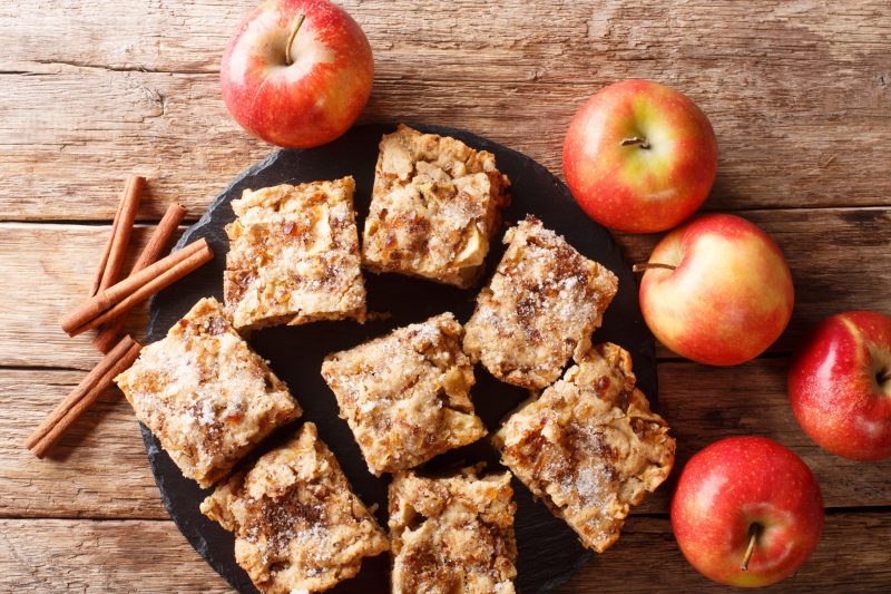 Top View Rustic-Style Apple Blondies Next to Fresh Apples on Wood | Vitacost Blog