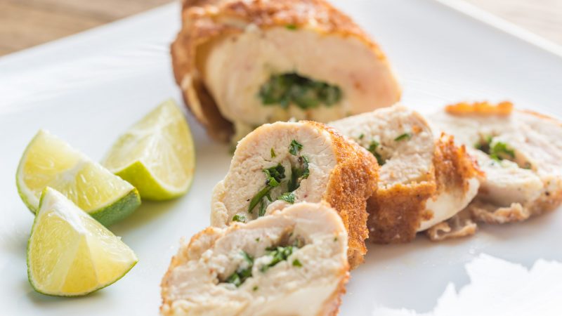 Chicken Kiev Cut into Slices Next to Lime Wedges | Vitacost Blog