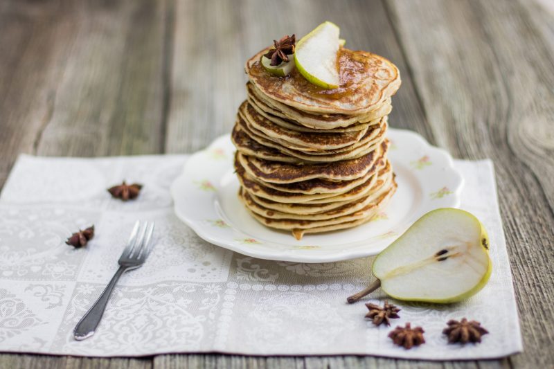 Tall Stack of Pancakes Garnished with Slice of Pear Next to Halves Pear | Vitacost Blog