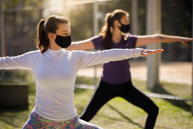 Woman Wearing Masks Focusing on Yoga and Immune System Health in Park Setting | Vitacost.com/blog