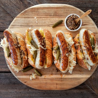 Top View Four Brats on Buns Topped with Sauerkraut and Mustard | Vitacost Blog