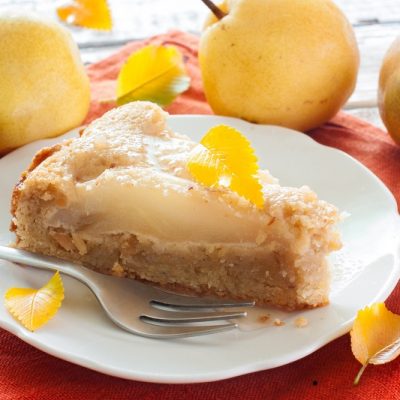 Slice of Pear Pie on White Plate Next to Fork in Front of Fresh Whole Pears | Vitacost Blog