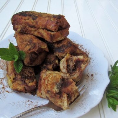 Brown French Toast Roll-ups on White Plate