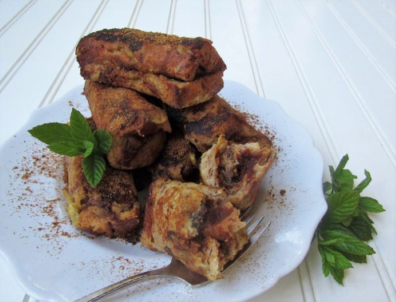 Brown French Toast Roll-ups on White Plate
