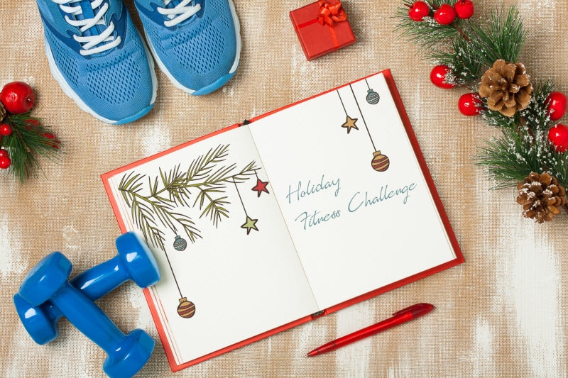 Holiday Fitness Challenge Scene With Weights, Sneakers and Fitness Journal on Wood Surface | Vitacost.com/blog