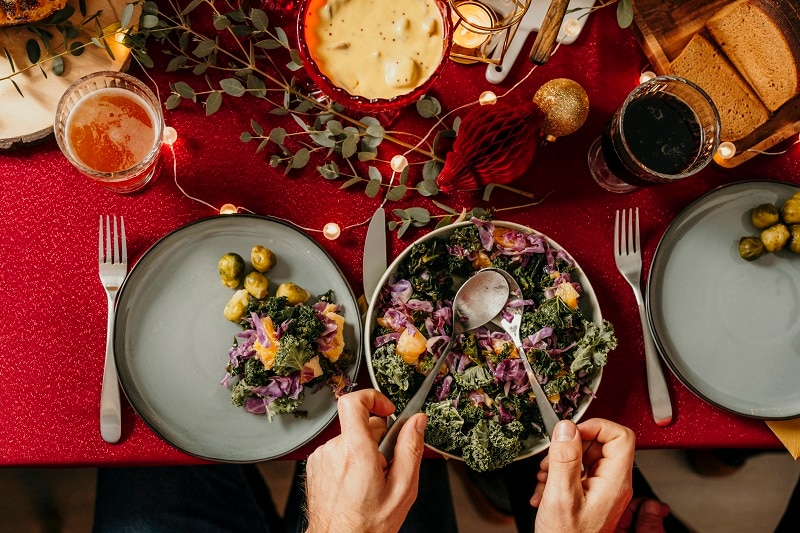 Person Serving Plant-Based Holiday Meal at Table | Vitacost.com/Blog