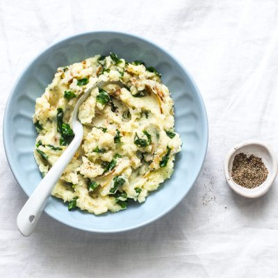 Top View Spinach-Loaded Mashed Potatoes in Blue Bowl with Silver Spoon | Vitacost Blog