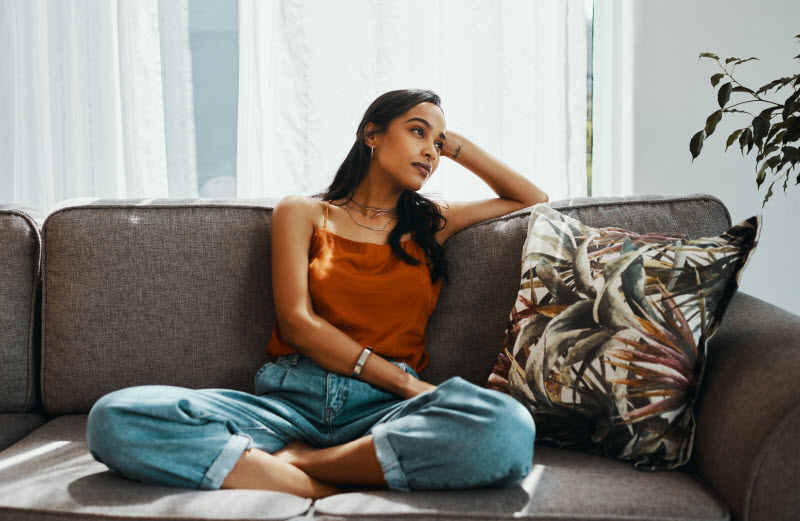 Woman Suffering From Seasonal Affective Disorder and Pandemic Depression Sitting on Couch | Vitacost.com/blog