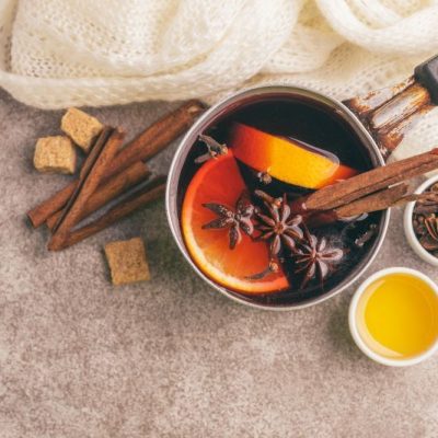 Mulled Wine in Vintage Pot with Orange Slices, Cinnamon and Star Anise on Marble