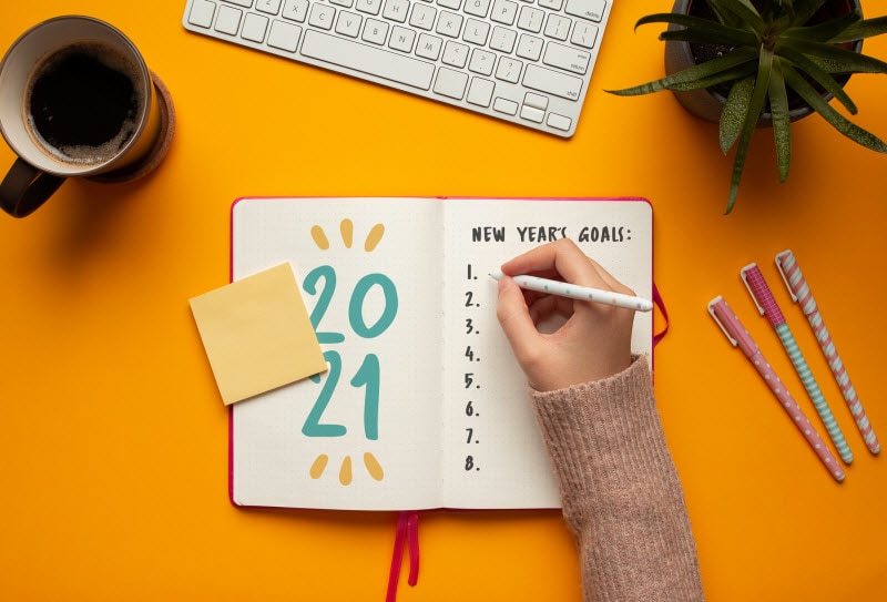 Woman Learning How to Form a Habit Writing in New Year's Goal Journal | Vitacost.com/blog