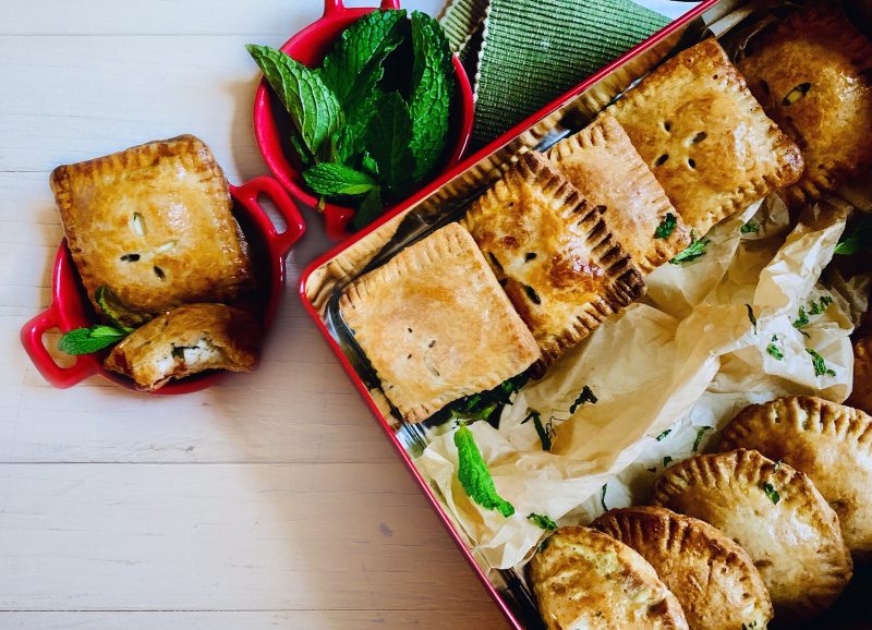 Red Pan with Rows of Baked Hand Pies Next to Single Hand Pie in Cup | Vitacost Blog