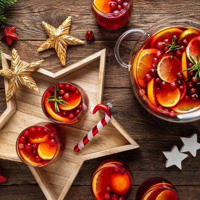 Top View Two Glasses of Fruity Tea on Star-Shaped Platter Next to Punch Bowl and Festive Decorations | Vitacost Blog