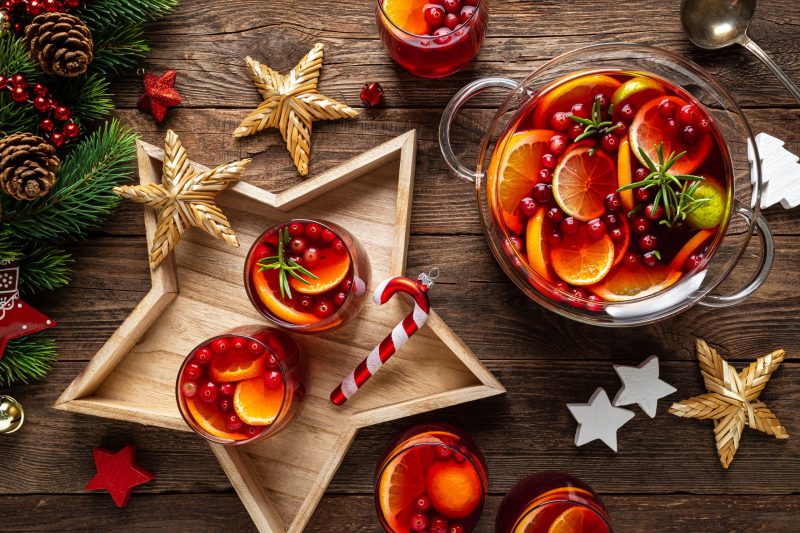 Top View Two Glasses of Fruity Tea on Star-Shaped Platter Next to Punch Bowl and Festive Decorations | Vitacost Blog