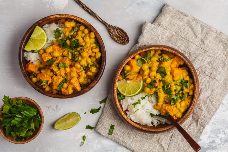 Top View Two Bowls of Curry Over Rice Garnished with Lime and CIlantro | Vitacost Blog