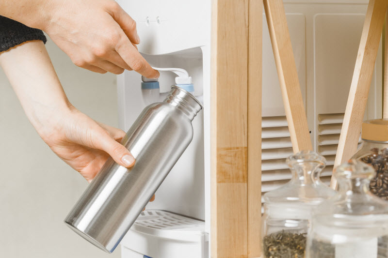 Concept of How to Clean Water Bottle Represented by View of Stainless Still Bottle Being Filled with Water | Vitacost.com/blog