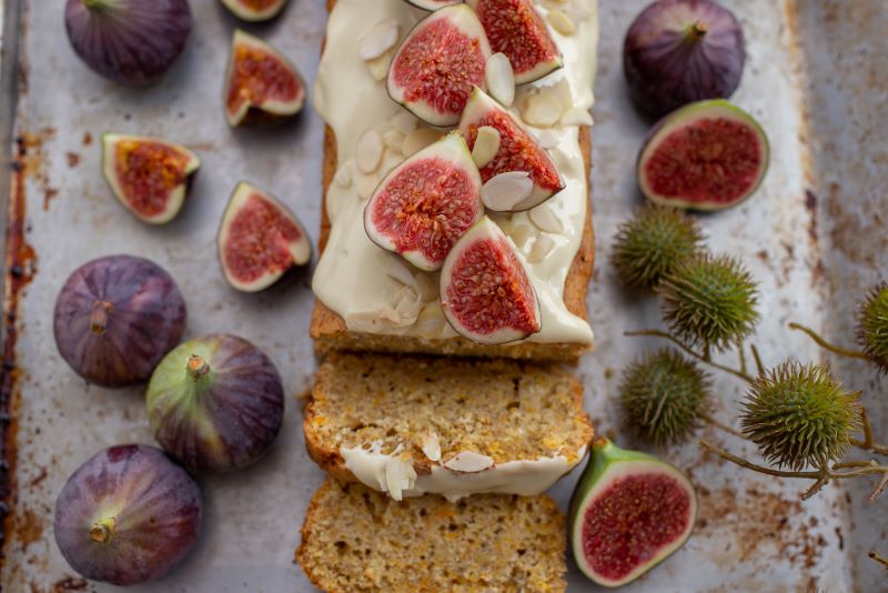 Fig and Almond Cake sliced on cutting Board with Whole Figs | Vitacost.com/blog