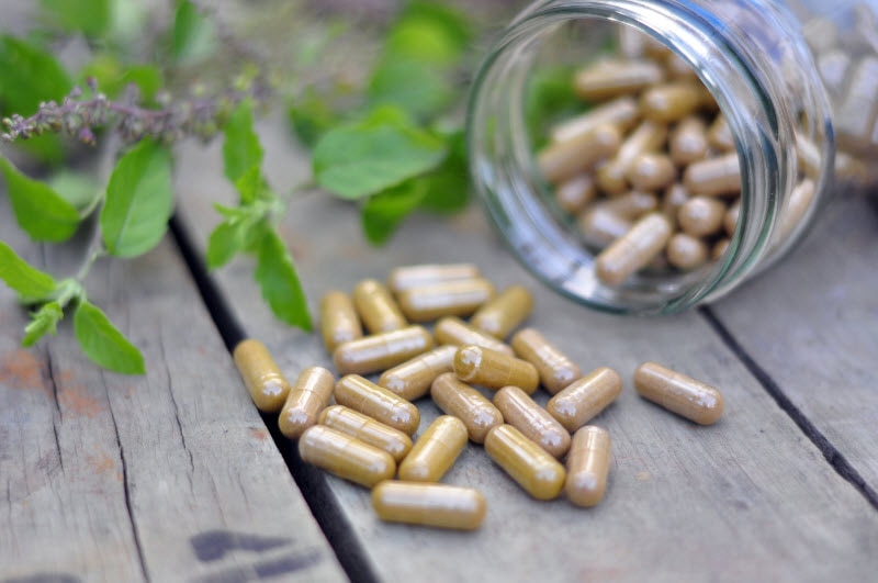 Herbs for Heart Health with Jar of Supplements Spilling onto Wooden Table | Vitacost.com/blog