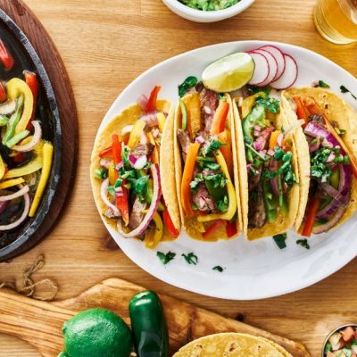 Vegetarian Fajitas on White Plate with Vegetables Sizzling in Skillet | Vitacost.com/blog