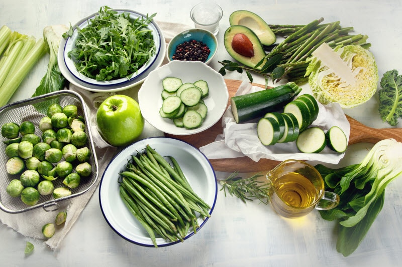 Ketotarian Diet Green Vegetables & Fruits Displayed on White Marble Table | Vitacost.com/blog