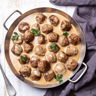Top View Swedish Meatballs in Sauce in Pan Garnished with Parsley | Vitacost Blog