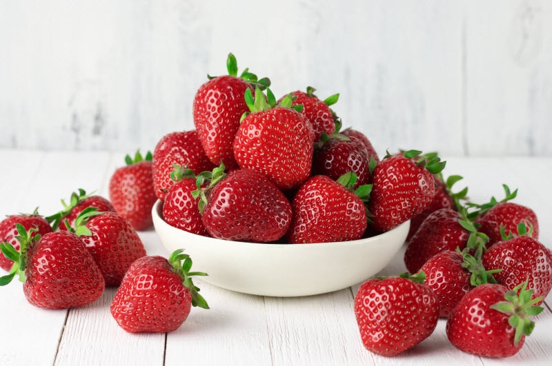 White Bowl Overflowing With Strawberries as Example of Ideal Red Food for Heart Health | Vitacost.com/blog