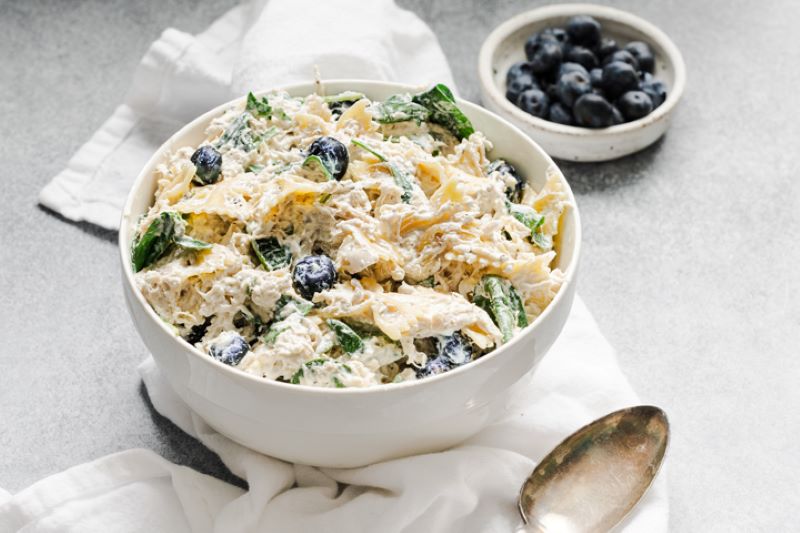 Healthy Chicken Pasta Salad in White Bowl with Blueberries | Vitacost.com/blog