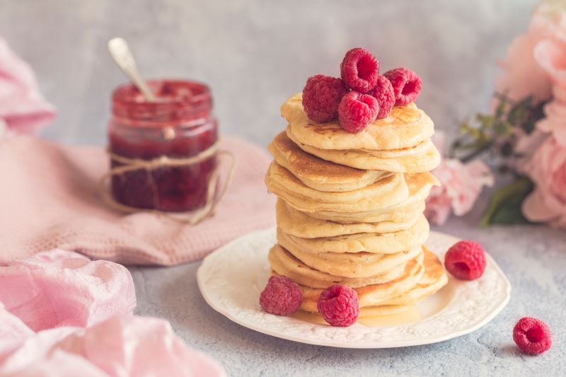 Eggless Pancakes Topped with Raspberries on White Plate | Vitacost.com/blog