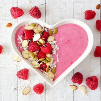 Homemade Raspberry Smoothie Bowl in Heart-Shaped Bowl Topped with Nuts, Seeds and Berries | Vitacost.com/Blog