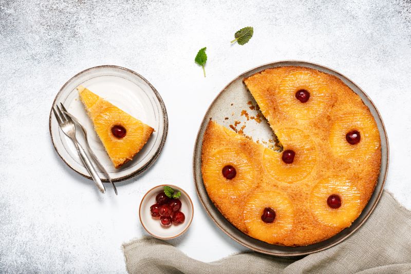 Pineapple Upside Down Cake on Stoneware Plate with Slice on Plate Next to It | Vitacost.com/blog