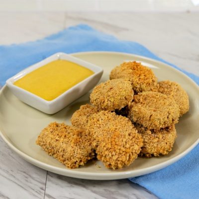 Oven-Baked Chickpea Nuggets on Plate with Dipping Sauce and Blue Napkin | Vitacost.com/Blog