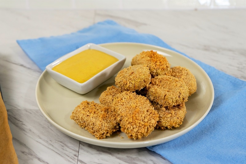 Oven-Baked Chickpea Nuggets on Plate with Dipping Sauce and Blue Napkin | Vitacost.com/Blog