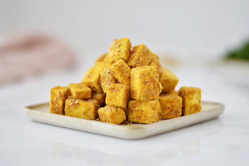 Stack of Curry-Dusted Cubed Tofu on White Plate