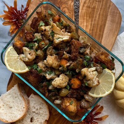 Roasted Cauliflower Stuffing with Sourdough Bread in Serving Dish on Wooden Serving Board | Vitacost.com/blog