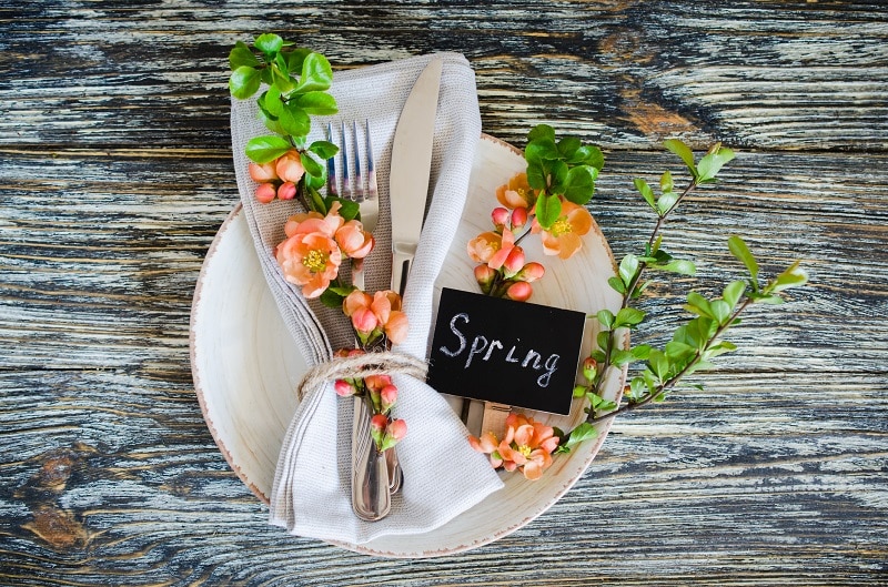 Utensils and Pink Flowers Wrapped in Cloth Napkin on Plate with "Spring" Label | Vitacost.com/Blog