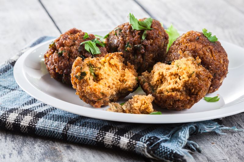 Homemade Chickpea Vegan Meatballs on White Plate with Plaid Napkin | Vitacost.com/blog