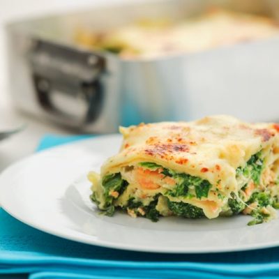 Slice of Dairy Free Lasagna with Spinach and Salmon on White Plate with Teal Napkin | Vitacost.com/blog