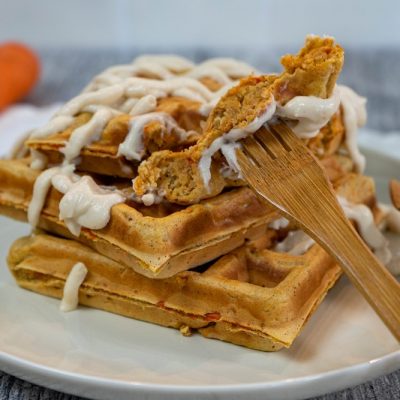 Homemade Vegan Carrot Cake Waffles Drizzled with Non-Dairy Maple Cream Cheese on Plate with Bamboo Fork | Vitacost.com/Blog